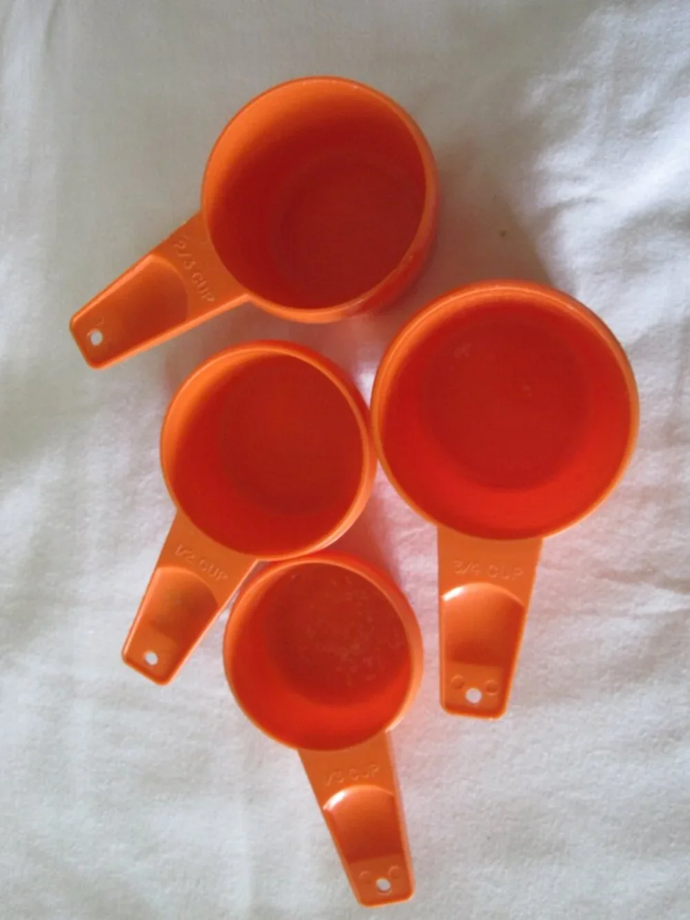 set of (4) vintage Tupperware Measuring Cups - Orange, 1/3, 1/2, 2/3, 3/4